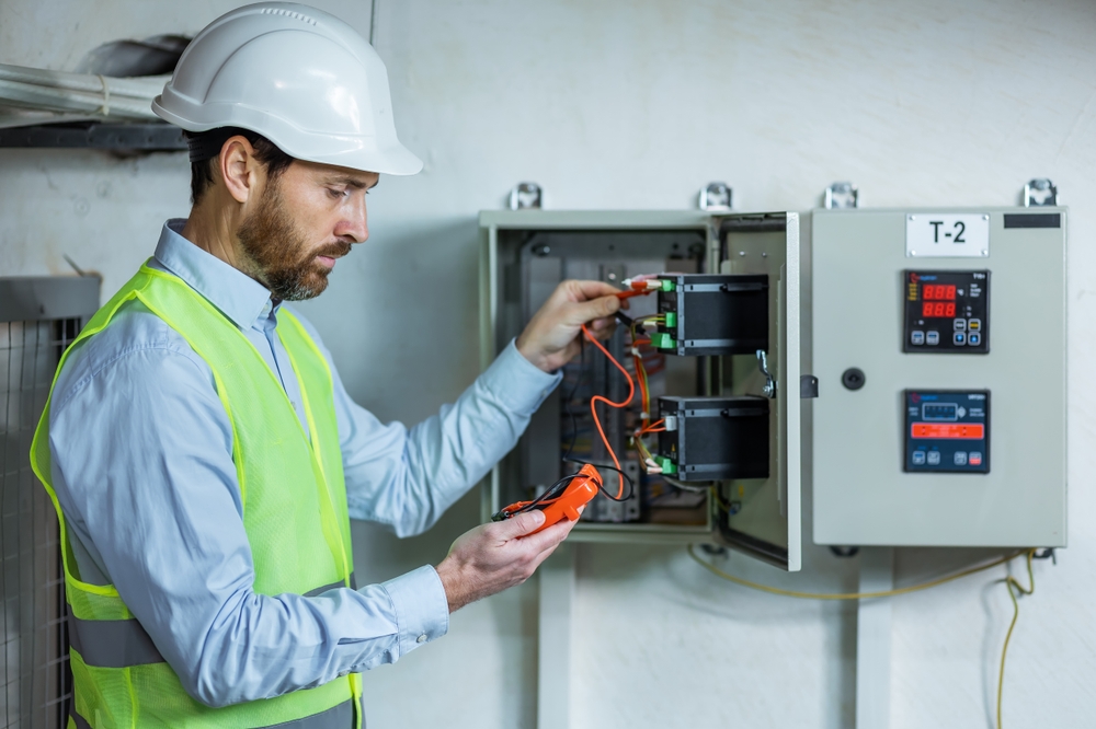 Commercial electrician installing an energy-efficient electrical panel in a commercial building.