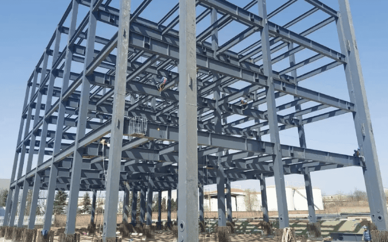 Engineers reviewing steel structure design plans for commercial building.