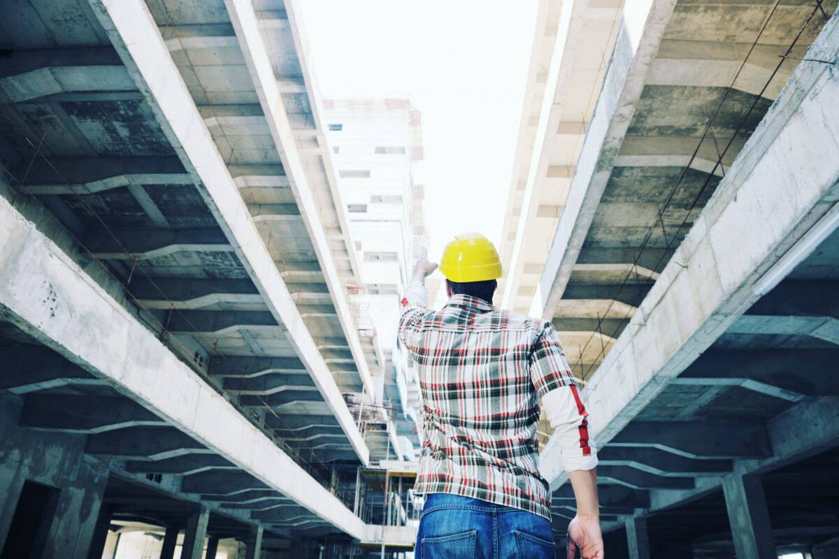 Commercial steel structure under construction with exposed steel beams and structural framing.